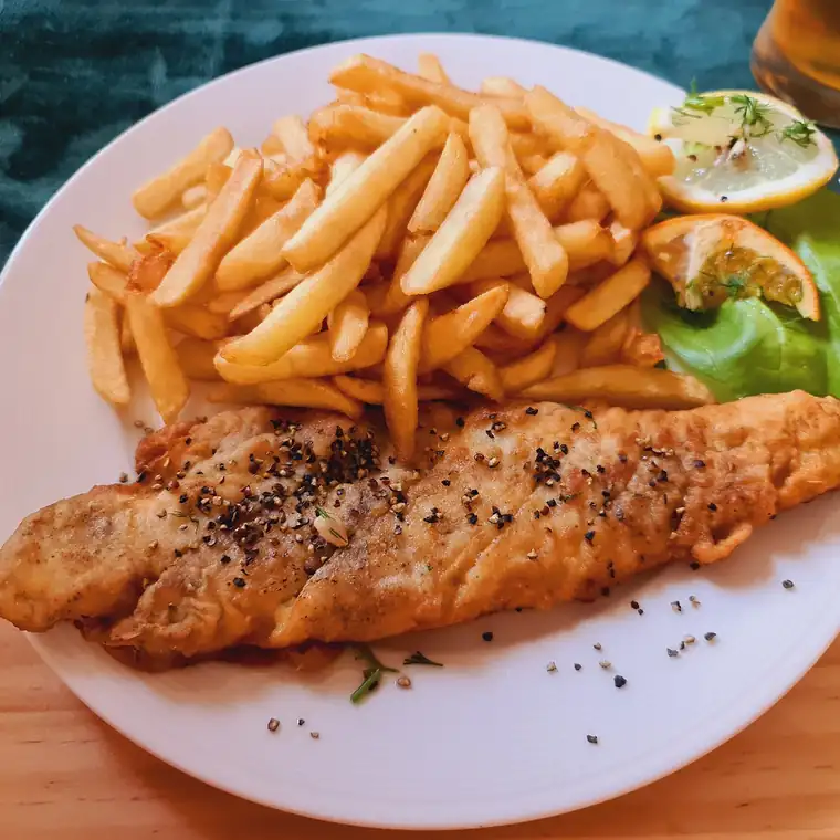 Smażony filet z dorsza z frytkami, cytryną i sałatą